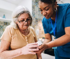 Nurse is showing a senior a perscription